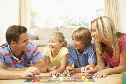 Family Playing Board Game At Home